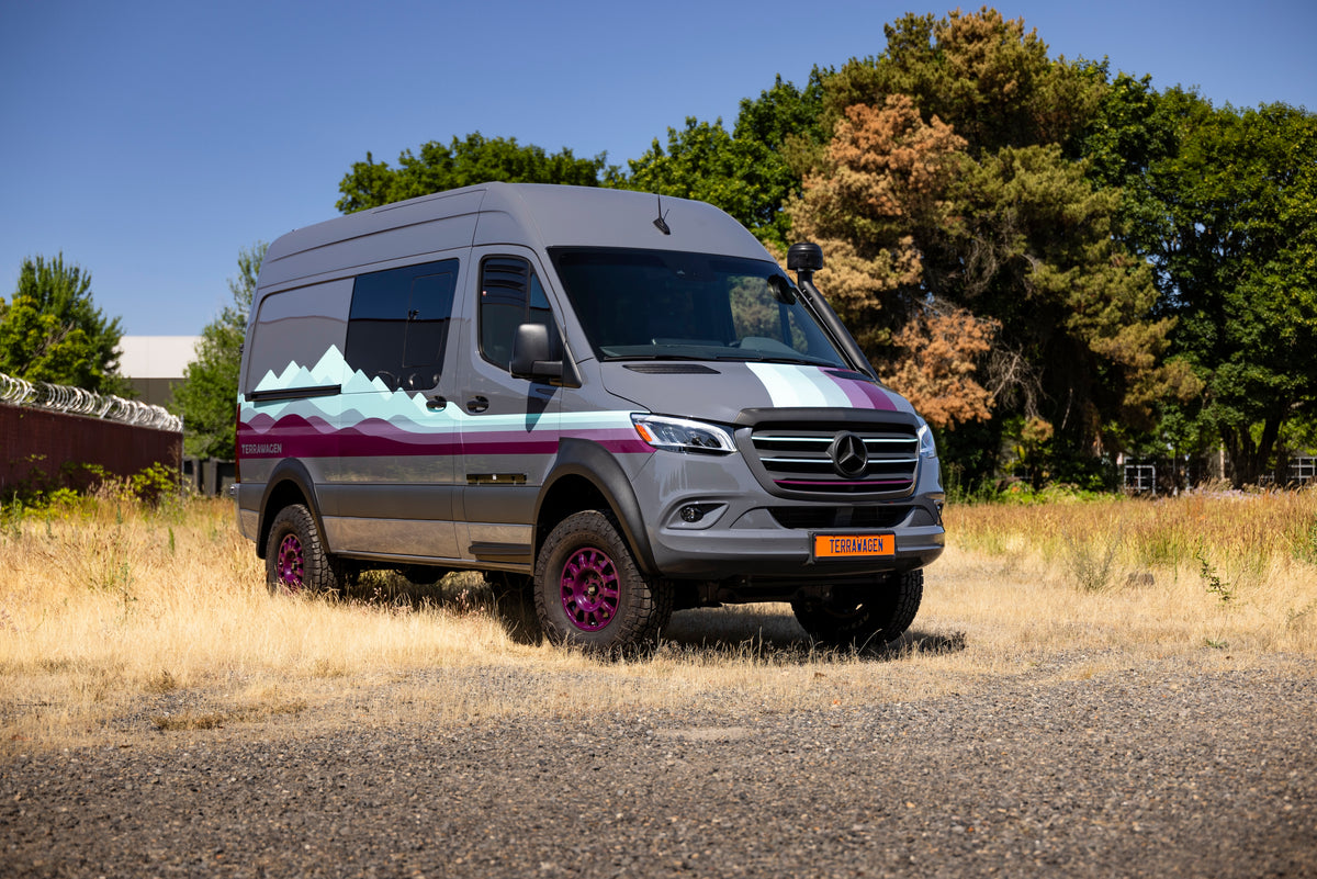 Grey Mercedes Sprinter with purple accents Mercedes Sprinter exterior front 3/4 hero, purple Braid wheels, snorkel, and all terrain tires