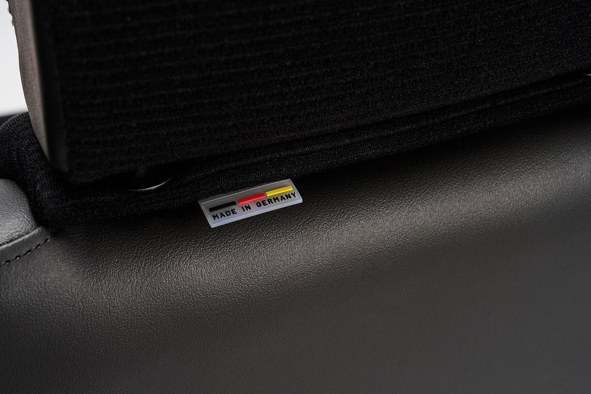 close up of the black scheel 101 seat corduroy headrest and made in Germany tag #color_Black Corduroy