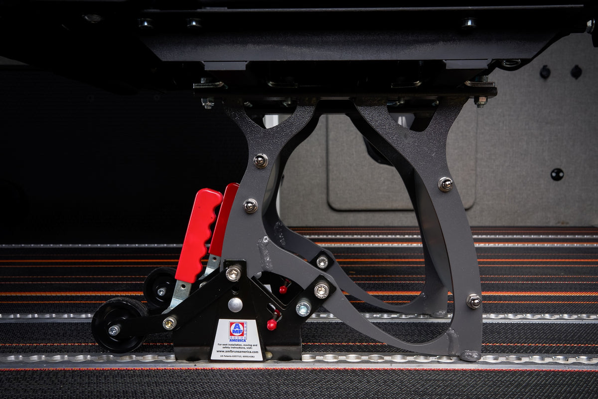 Detail of the Smartleg quick release seat base with gray legs, red release handles, and rear wheels, resting on a Smartfloor aluminum rail