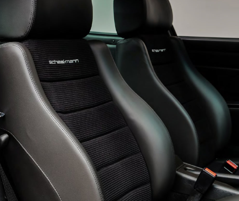 Pair of scheel-mann seats in leather and corduroy with a clean, matte finish