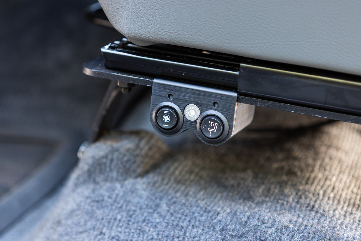 Dual switch mount installed on a driver seat mounted on the left side of the seat bracket, detail close up