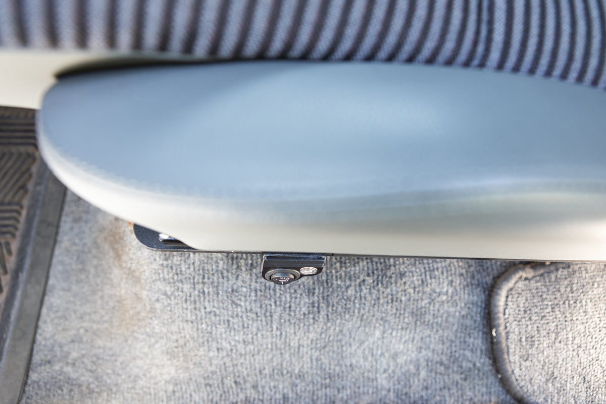 Single switch mount installed on a driver seat mounted on the left side of the seat bracket, showing bottom cushion and left bolster in gray, looking top down