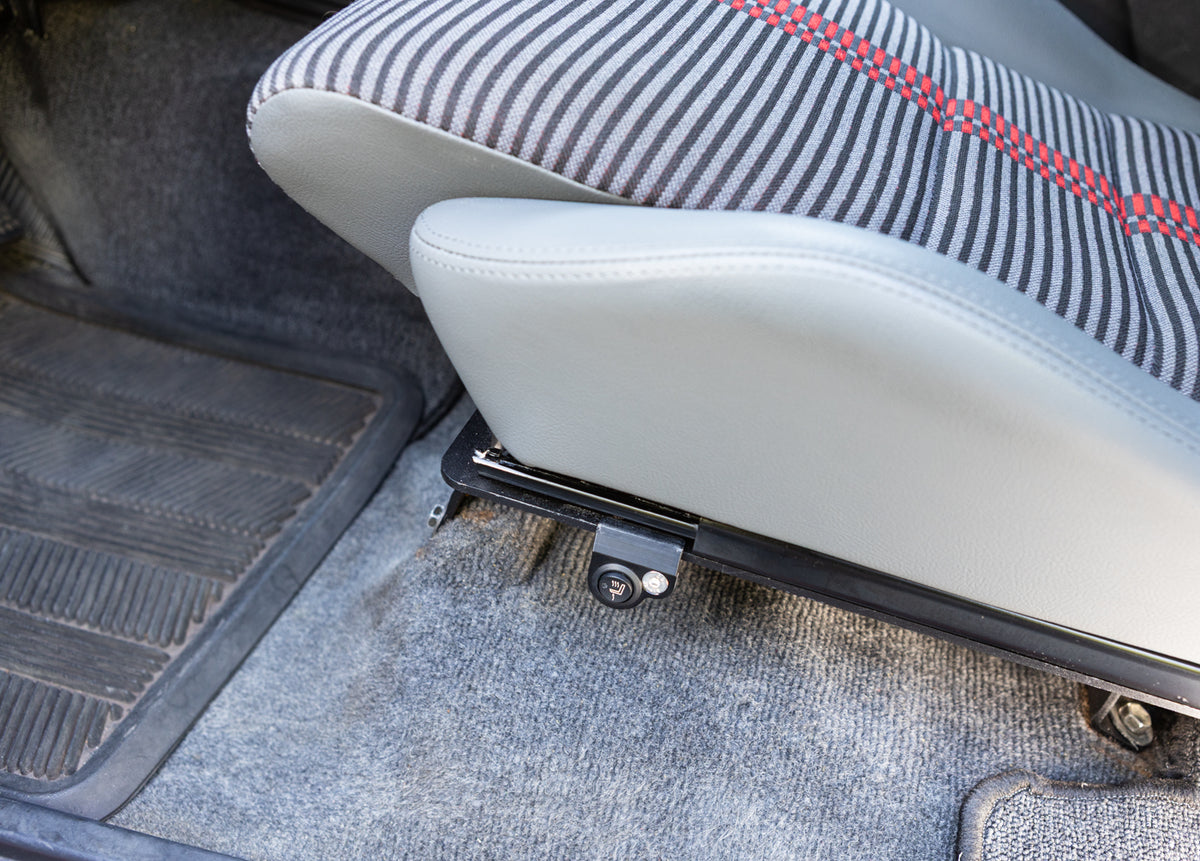 Single switch mount installed on a driver seat mounted on the left side of the seat bracket, showing bottom cushion and left bolster in gray